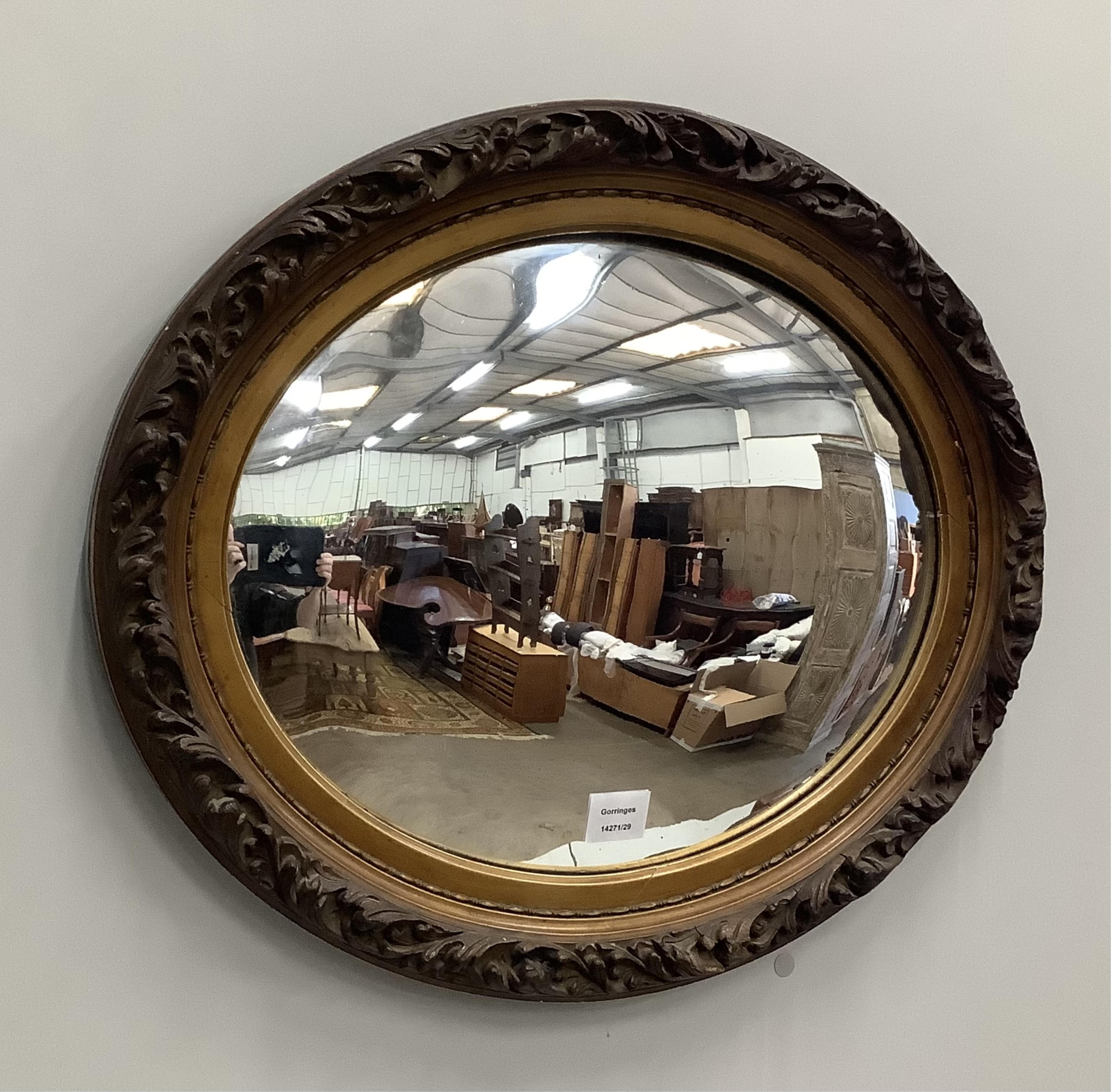 An Edwardian oval gilt framed convex wall mirror, width 62cm, height 51cm